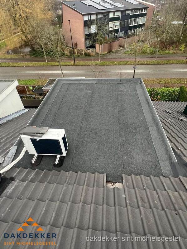 Plat dak inspectie met bitumen bedekking naast schuin pannendak in Sint Michielsgestel